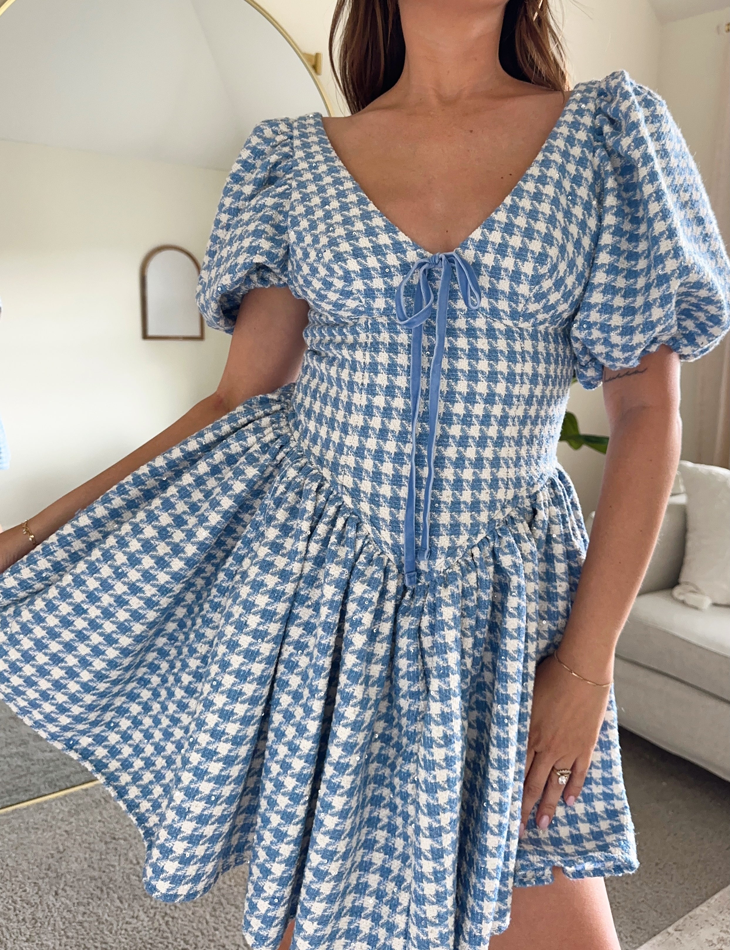 Blue and white tweed gingham puff sleeve mini dress with drop waist and tie detail. 