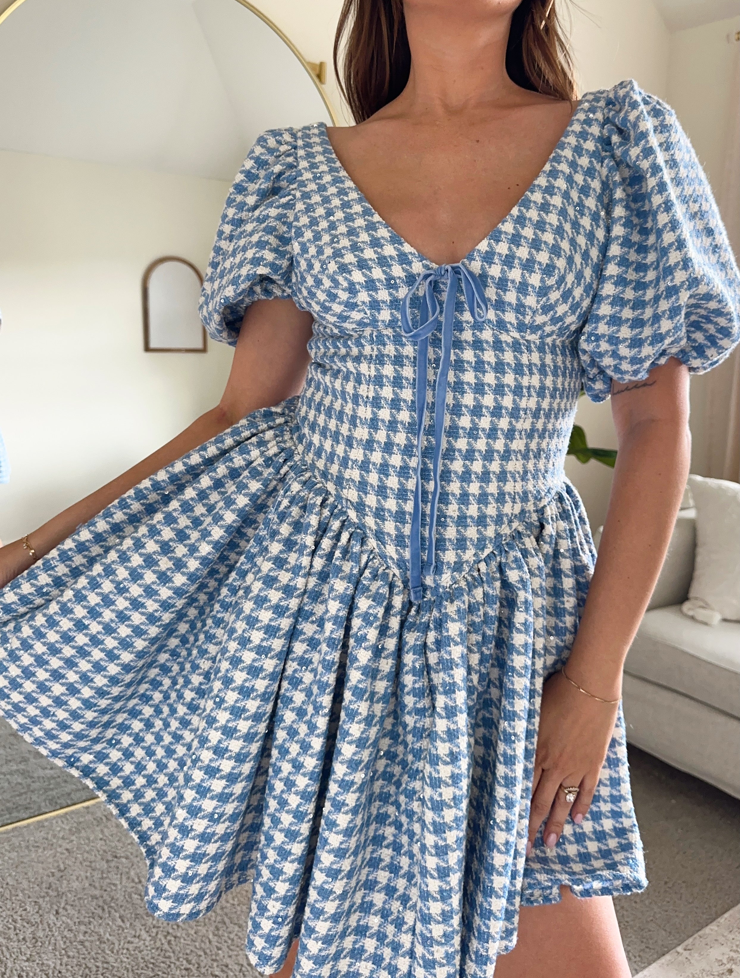 Blue and white tweed gingham puff sleeve mini dress with drop waist and tie detail. 